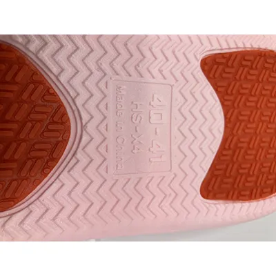 Pink slippers made of PVC plastic. Product sold online.