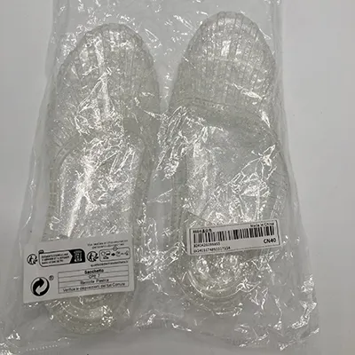 Sandals made of transparent PVC plastic with glitter. Product sold online.