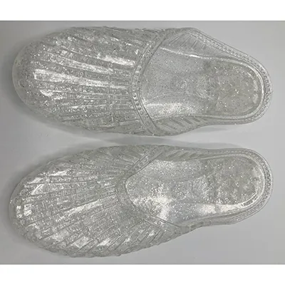 Sandals made of transparent PVC plastic with glitter. Product sold online.