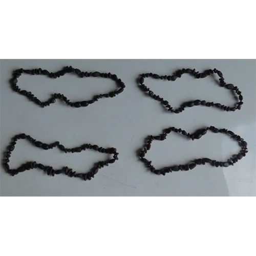 Necklace consisting of beads threaded on a brown cord with a plastic screw clasp intended for children under three years. Product sold online, in particular via eBay (Article number 223544161944).