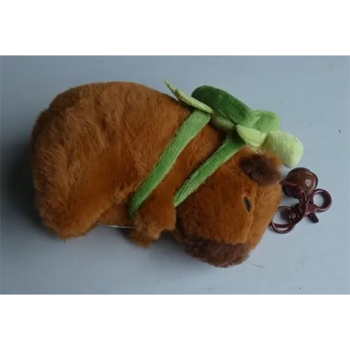 Plush keyring with metal carabiner clasp and a bell in the shape of a marmot wearing a detachable green turtle plush backpack. Product sold online, in particular via Wish.