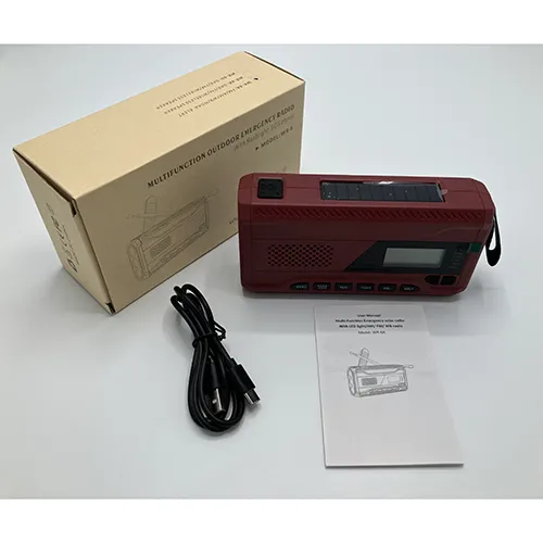 Maroon/burgundy radio with black details. Fitted with a crank, solar panel, antenna, textile strap and a small display window. Includes a black USB/USB-C cable.