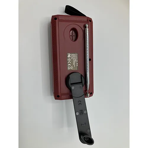Maroon/burgundy radio with black details. Fitted with a crank, solar panel, antenna, textile strap and a small display window. Includes a black USB/USB-C cable.