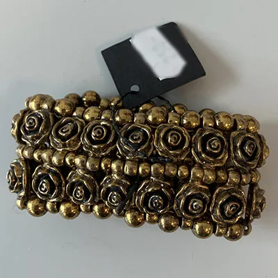 Golden-coloured bracelet with roses.
