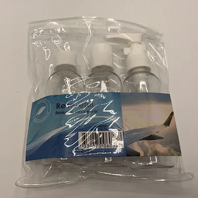 Transparent travel case with three transparent bottles.
