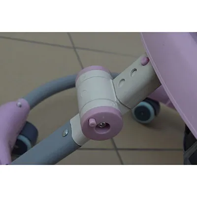 A pink and white musical baby walker, made of plastic and metal parts. The word 