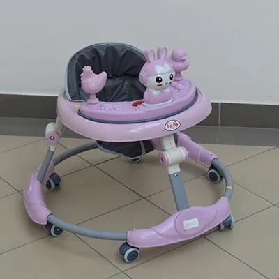A pink and white musical baby walker, made of plastic and metal parts. The word 