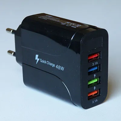 USB charger with black plastic cover, integrated mains plug and four USB-A sockets.
