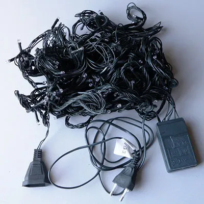 Decorative lighting chain with control unit. It consists of 180 purple LEDs and pine green insulated wires.