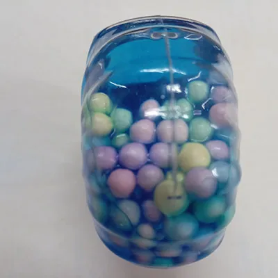 Slime of blue colour with coloured balls.