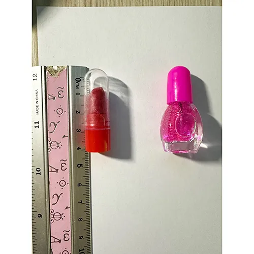 Plastic doll with accessories such as artificial nails, nail polish and a purse.