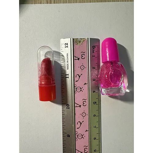 Plastic doll with accessories such as artificial nails, nail polish and a purse.