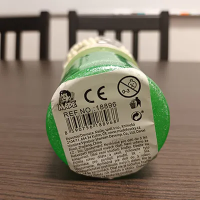 Green toy slime. Comes together with small colourful balls, in a separate compartment.