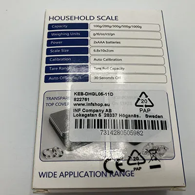 Small (6.8x10x2 cm) digital scale with a black plastic exterior, transparent weighing plate cover, LCD display and a pair of buttons.