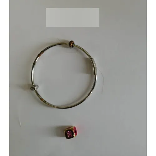 Steel bracelet with a cube.