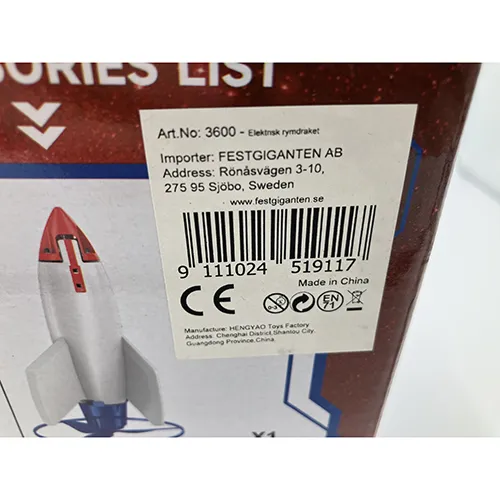 White foam toy rocket, approx. 30 cm in height, fitted with a red plastic propeller base powered with a USB cable including a remote control and a blue launch pad.