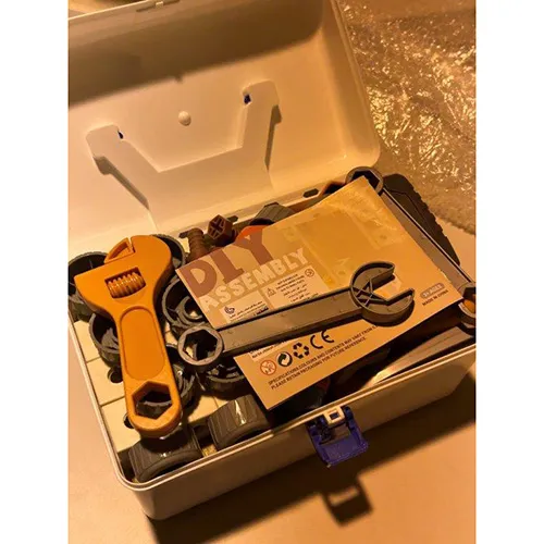 White and blue plastic toolbox, measuring approximately 40x30x30 cm. Filled with playing tools (including a battery-operated screw driver)