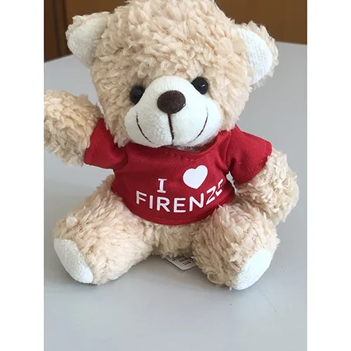 Teddy bear approximately 17 cm tall with a T-shirt bearing the words ‘I love Firenze’. A fabric ring is sewn to the top of the head so that the toy can be hung up.