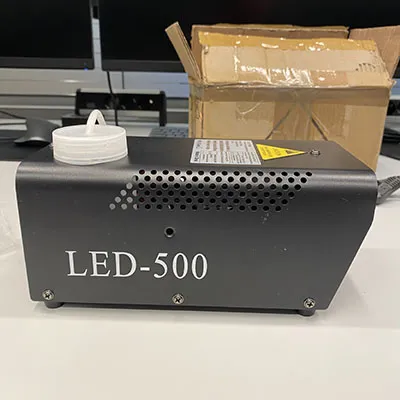 Fog machine for mobile DJ's, parties, small venues with internal RF-receiver (incorporated in internal LED-driver) and an external pluggable RF-receiver (via a 3-pin XLR socket-plug combination) and two remote controls. Product sold online, in particular via djlicht.nl.