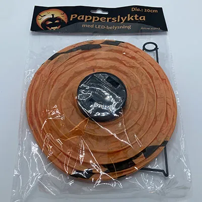 Orange lantern, reminiscent of a Halloween pumpkin. 20 cm in diameter with black plastic details.