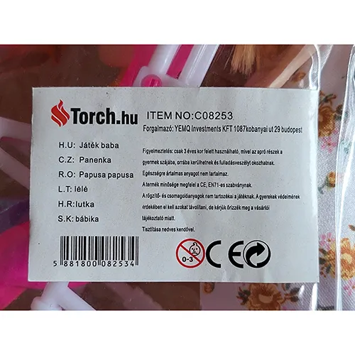 Plastic doll of 26 cm with hair in a ponytail in a dress with flowers and plastic accessories and red shoes.