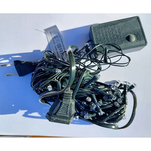 Decorative lighting chain with amber LEDs and a dark green insulated wire, with an eight-program control unit and an extension option.