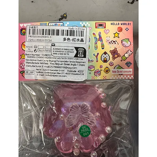 Slime toy shaped like a cat's paw with loose beads/figurine.