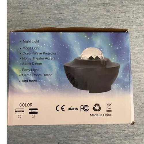 Projector light in the form of moving galactic nebulae and a starry sky. The galactic nebulae are projected via a transparent crystalline hemisphere in the upper part of the projector. Product sold online, in particular via Kaufland.de
