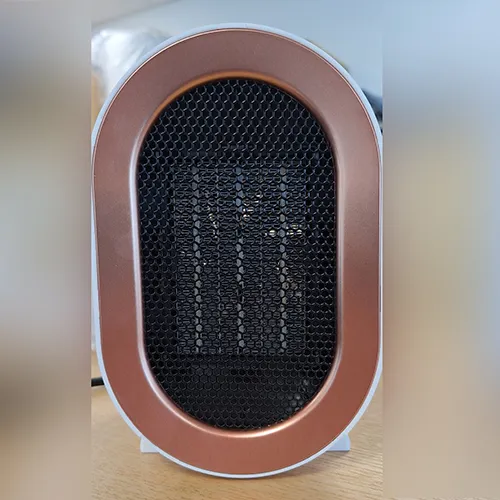Oval-shaped white fan heater with a black grille and a black power cord attached. Product sold online, in particular via Amazon (ASIN: B0CMCZT6QR).
