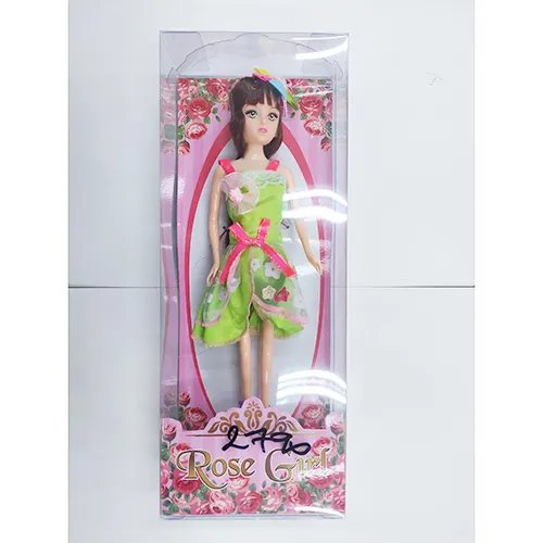 Plastic doll in a green dress.