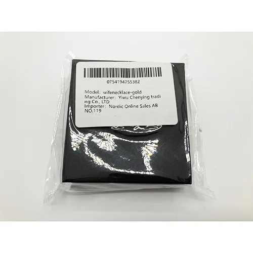 Gold-coloured necklace with a rhinestone-studded charm.