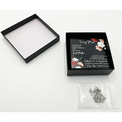 Silver-coloured necklace with a rhinestone-studded charm.