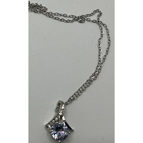 Silver-coloured necklace with a rhinestone-studded charm.