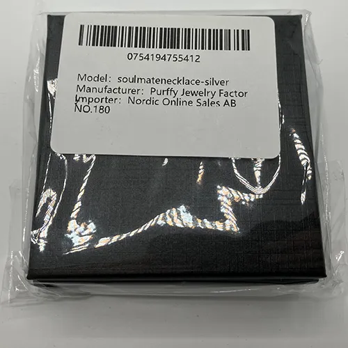 Silver-coloured necklace with a rhinestone-studded charm.