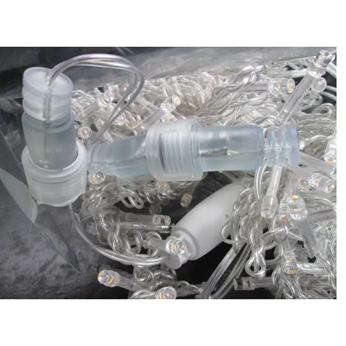 Lighting chain with blue LED lights, colourless insulated wire, and a socket that allows extension with additional members.