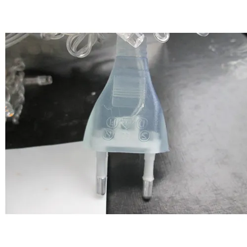Lighting chain with blue LED lights, colourless insulated wire, and a socket that allows extension with additional members.