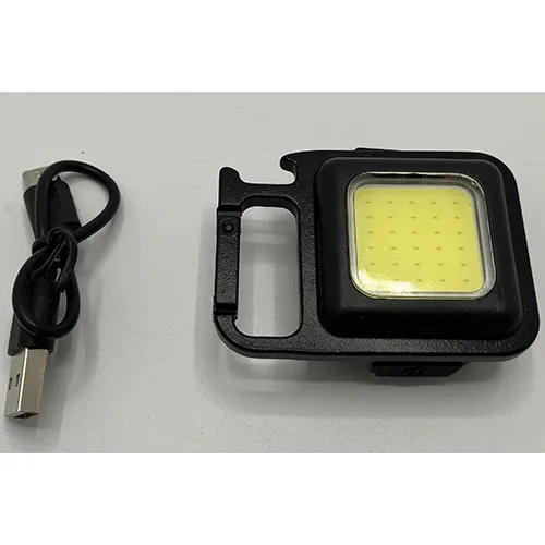 Carabiner fastened flashlight, about 4x4 cm intended to function as a bottle opener. Product sold online, in particular via mylar.se.