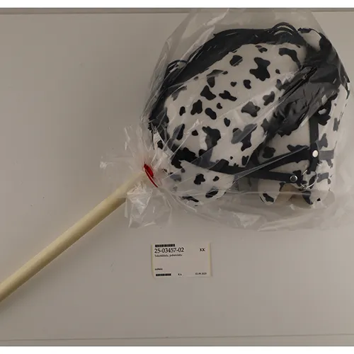 Dark brown and white and black hobby horses with a wooden stick. Both horses have a black mane and a black bridle.