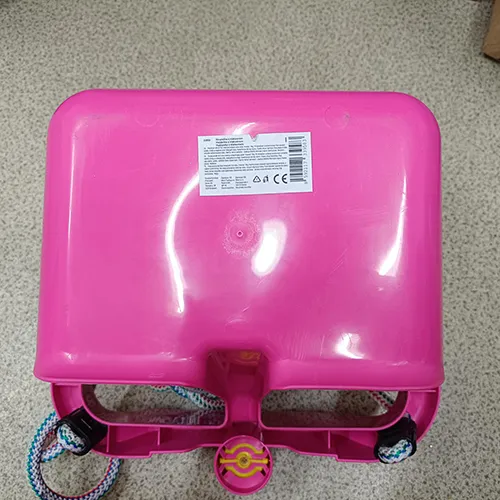 Hanging plastic toy swing. The hanging system consists of a rope that is anchored in each corner of the swing and ends in two connectors with plastic ends. A plastic horn is located in the front center part.