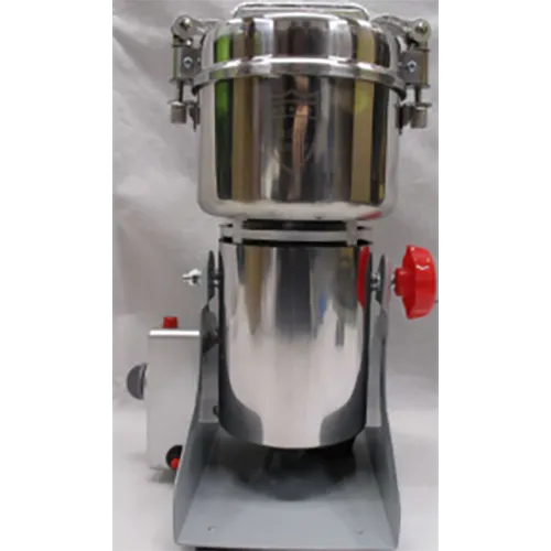 Small metal countertop crushing tool with a wall plug, spare blades and measuring spoons.