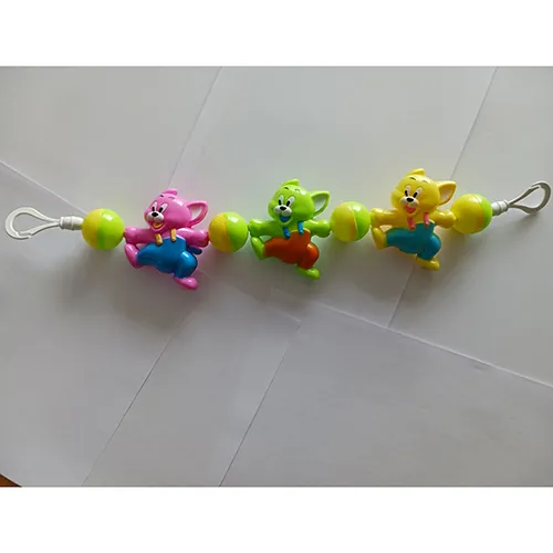 Colourful rattle toy with plastic cats and balls, strung on a rubber band, designed to be tied across a cradle, crib or stroller with hooks.