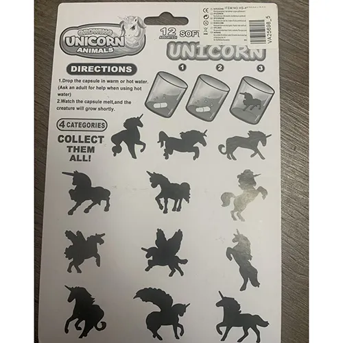 Toy set of twelve coloured (pink, blue, yellow and green) capsules. Inside each capsule is a compressed soft foam figure in the shape of an unicorn of various shapes.