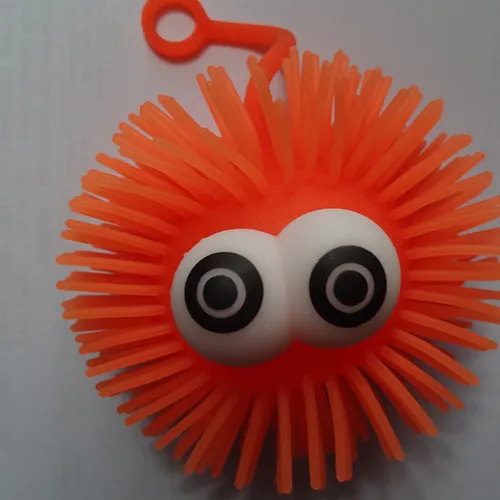 Elastic toy yoyo ball with spikes and a light source inside.