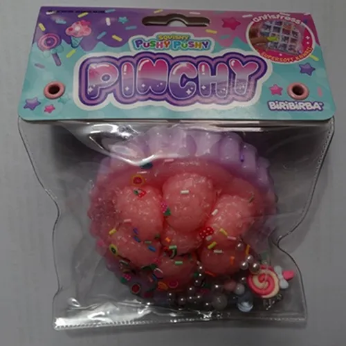 Anti-stress toy, 10cm long, made of purple-pink soft plastic confectionery (tartlet with berries) with multi-coloured plastic sprinkles, coloured/pearl balls of various sizes, with plastic candies (2 cm) and a flower (1.5 cm).
