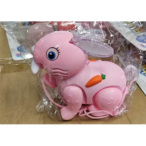 Pink plastic rabbit toy, with a switch. The toy moves forward, lights up and produces music when switched on.