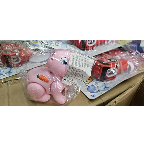 Pink plastic rabbit toy, with a switch. The toy moves forward, lights up and produces music when switched on.