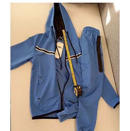 Children's clothing set intended for young children, made of light blue textile knit material. It is composed of a jumper with hood, zipper and inset pockets. The hood has a drawstring functional textile cord with free ends about 24 cm long. It also includes a pair of trousers made of light blue textile knit material and with inset pockets.