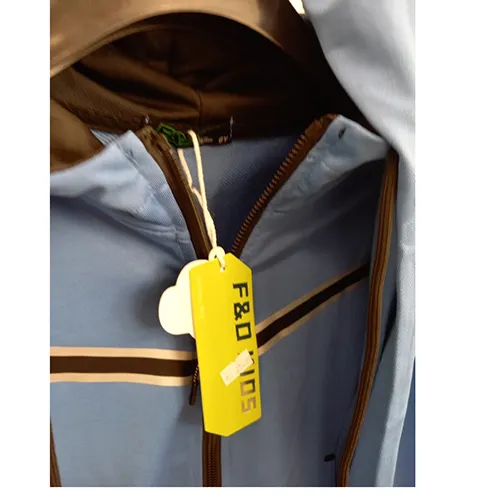 Children's clothing set intended for young children, made of light blue textile knit material. It is composed of a jumper with hood, zipper and inset pockets. The hood has a drawstring functional textile cord with free ends about 24 cm long. It also includes a pair of trousers made of light blue textile knit material and with inset pockets.