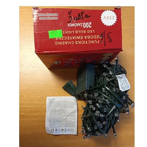 Lighting chain consisting of green wires, 200 white LED bulbs and a green plastic control panel for setting 8 different light functions.