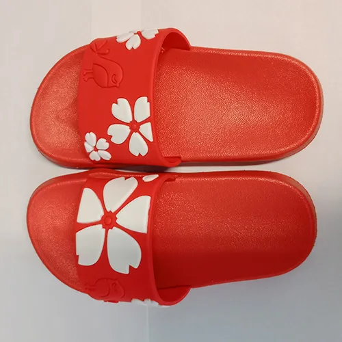 Children's red slip-on shoes made of soft plastic with a pattern of a red bird and white flowers on the buckle, size 24, 25.